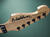 Grover tuners atop a reverse headstock